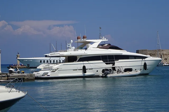 A large motor yacht lying alongside a harbour quay