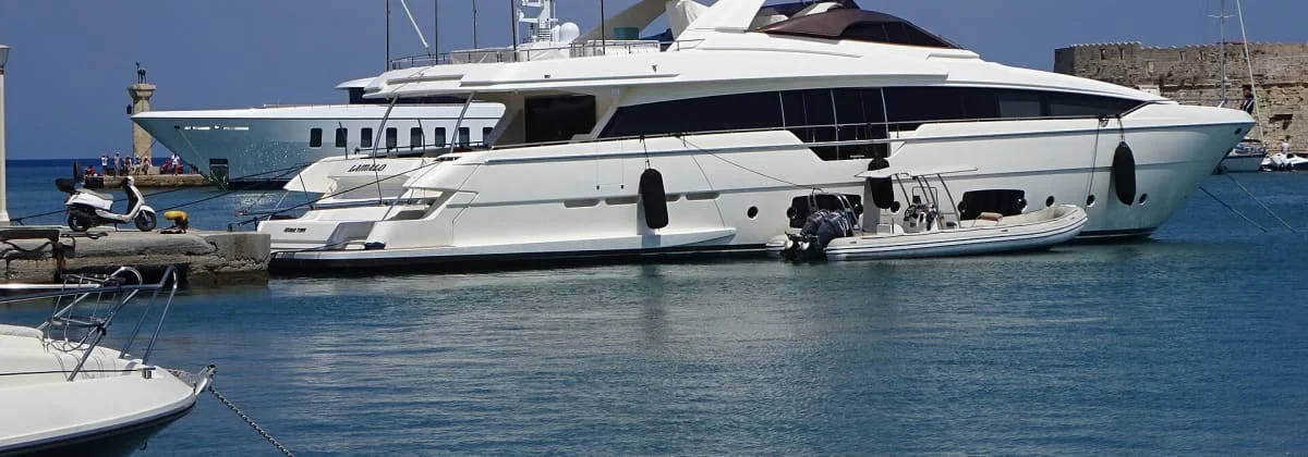 A large motor yacht lying alongside a harbour quay