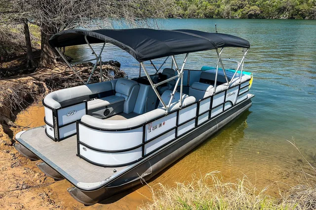 Pontoon boats moored side by side at a lakeside dock