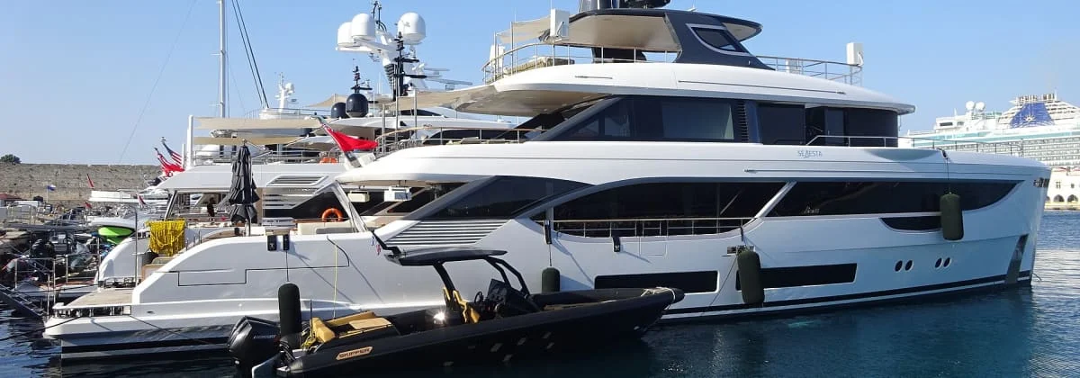 A motor yacht berthed alongside a harbour quay