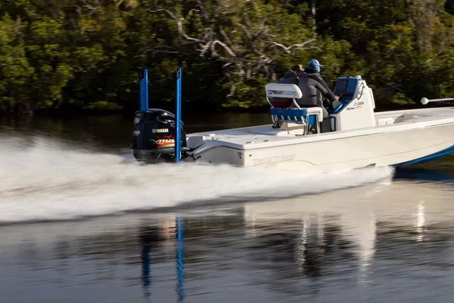 Pathfinder 2300 HPS bay boat running fast along a mangrove shoreline
