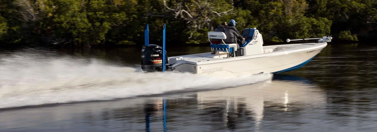 Pathfinder 2300 HPS bay boat running fast along a mangrove shoreline