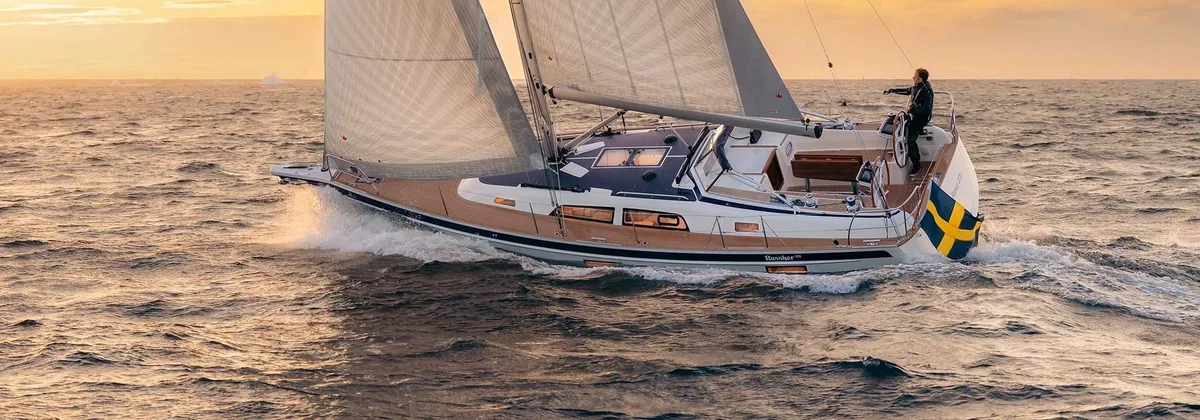 Hallberg-Rassy 370 bluewater cruising yacht sailing at sunset