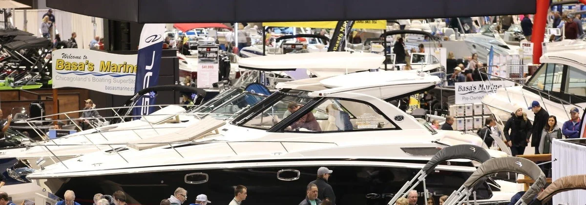 Visitors walking among cruisers on the floor of the Chicago Boat Show