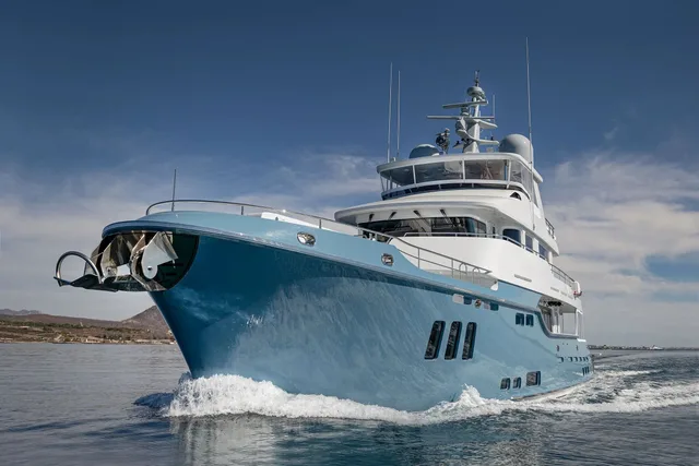 Nordhavn 96 explorer yacht with a blue hull under way
