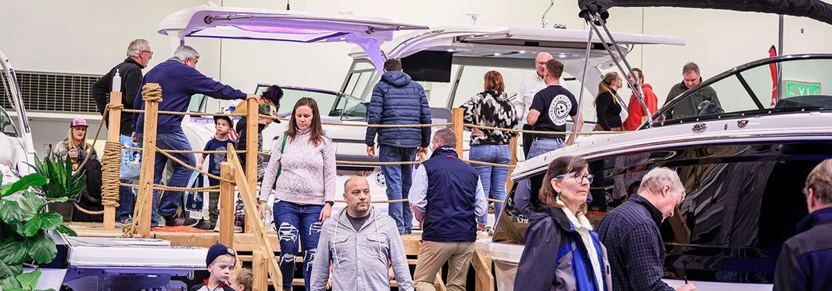 Visitors boarding a display boat at the Minneapolis Boat Show