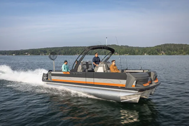 Avalon pontoon boat with an arch running across a lake with passengers
