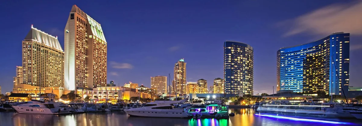San Diego waterfront hotels and moored boats lit up at night