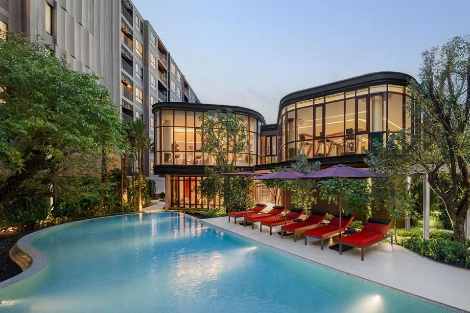 The Base Cherngtalay, pool and glass-walled clubhouse