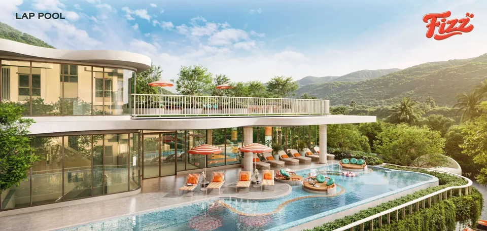 The FIZZ clubhouse with its 25 by 5 metre lap pool, orange sun loungers and green Kata hills behind