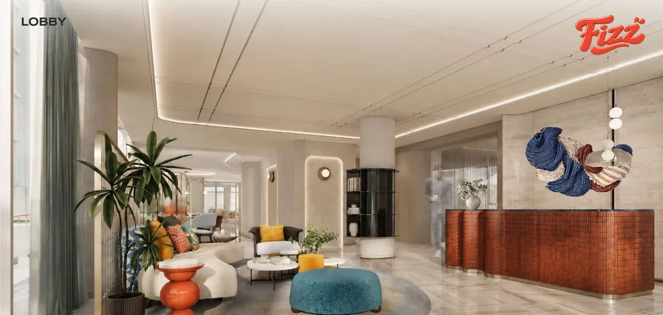 FIZZ lobby with a terracotta reception desk, curved sofa and teal and orange furniture
