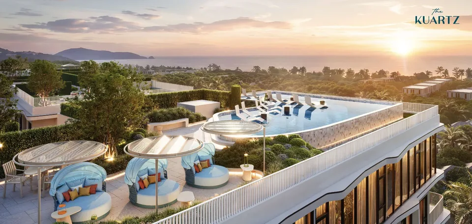 Rooftop of The Title KUARTZ at sunset with the sky pool, shaded cabanas and a view over Karon to the sea