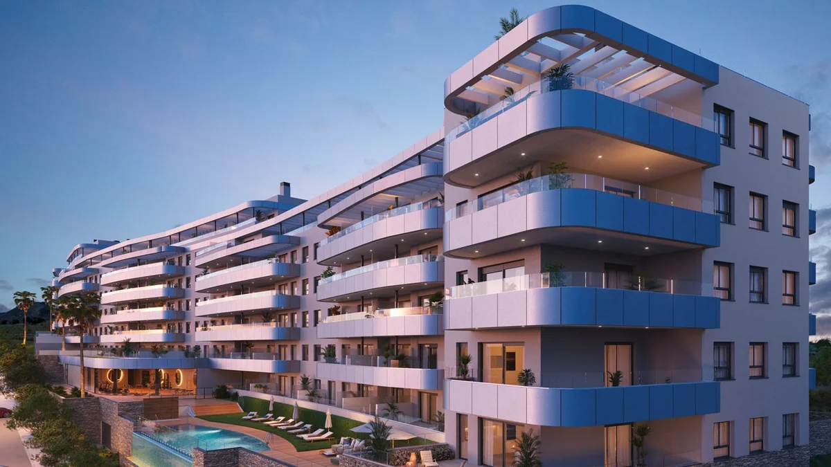 One Oak by Kronos Homes in Torremolinos: curved balconies of the residential blocks at dusk