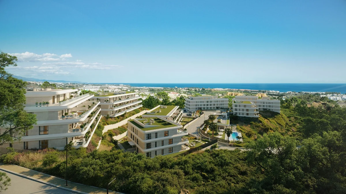 Aerial view of Australy Aures apartments among pine hills with the Mediterranean in the distance, Estepona