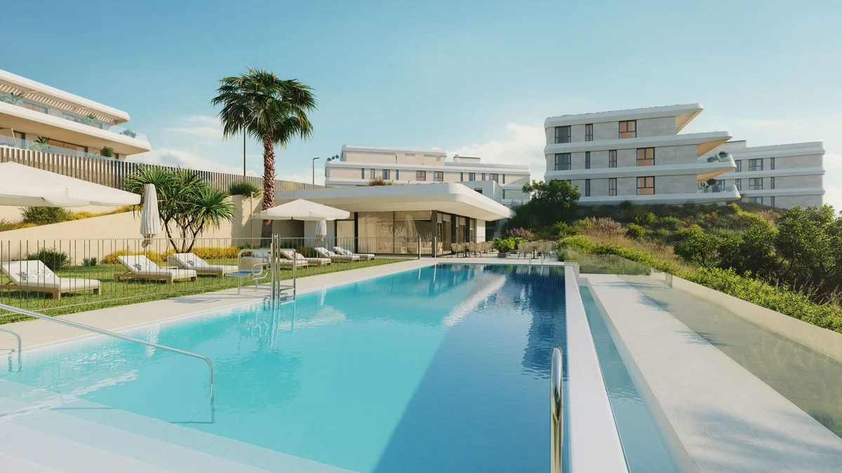 Australy Aures community swimming pool with apartment buildings behind, Estepona