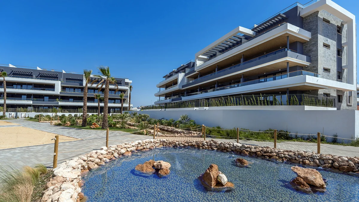 Apartment blocks with a landscaped water feature at Lagoons Village, Torrevieja
