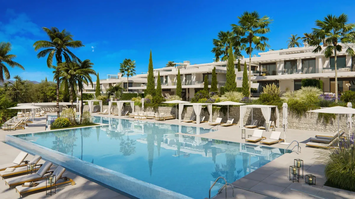 Communal infinity pool and white apartment blocks at Soul Marbella Sunlife by AEDAS Homes, Santa Clara Golf, Marbella